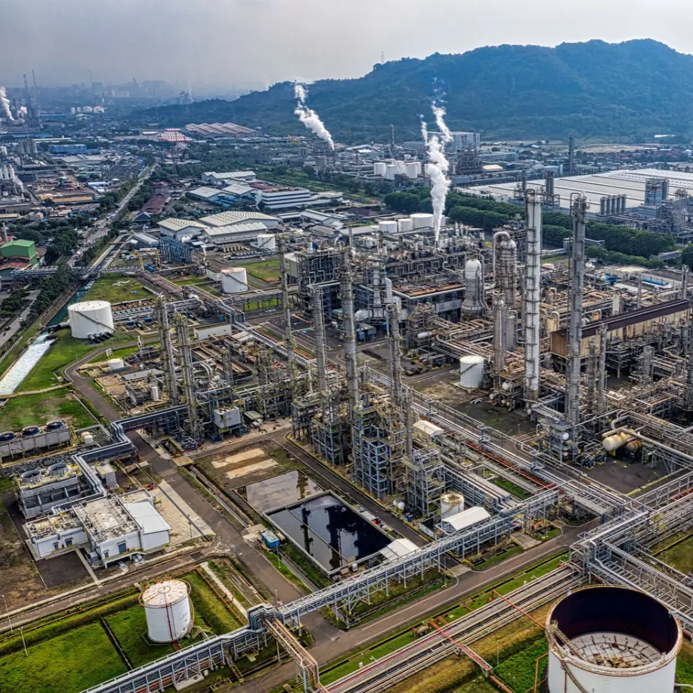 Aerial view of an oil and gas processing facility with piping, storage tanks and process equipment